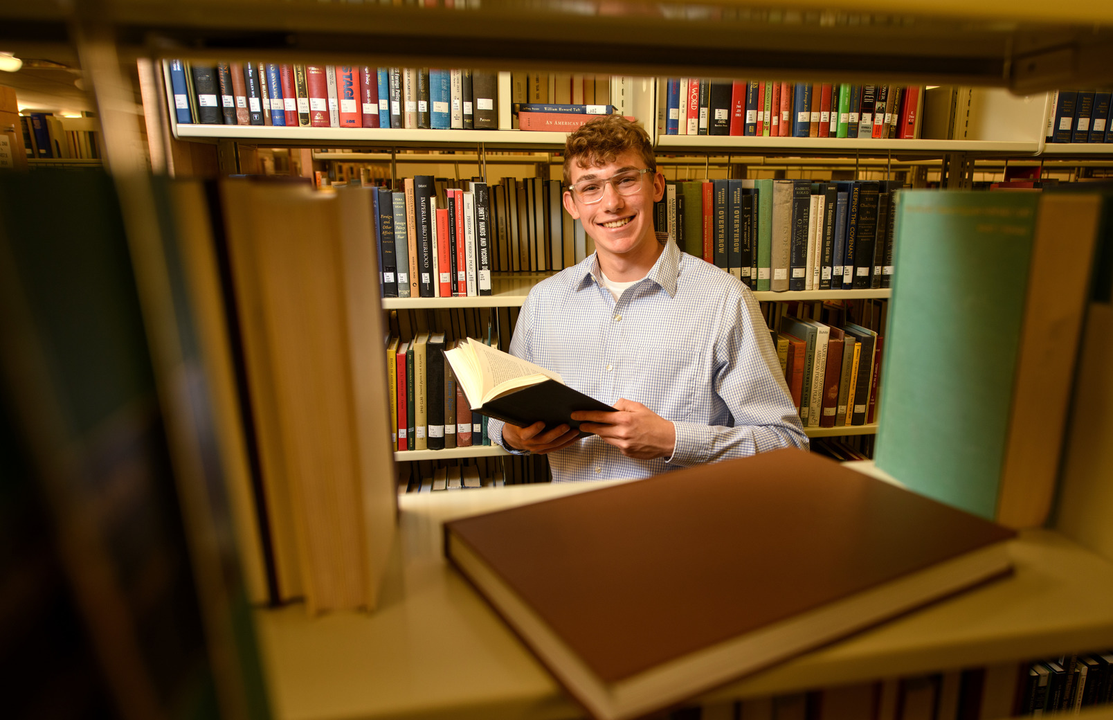 Student smiling for picture in the library