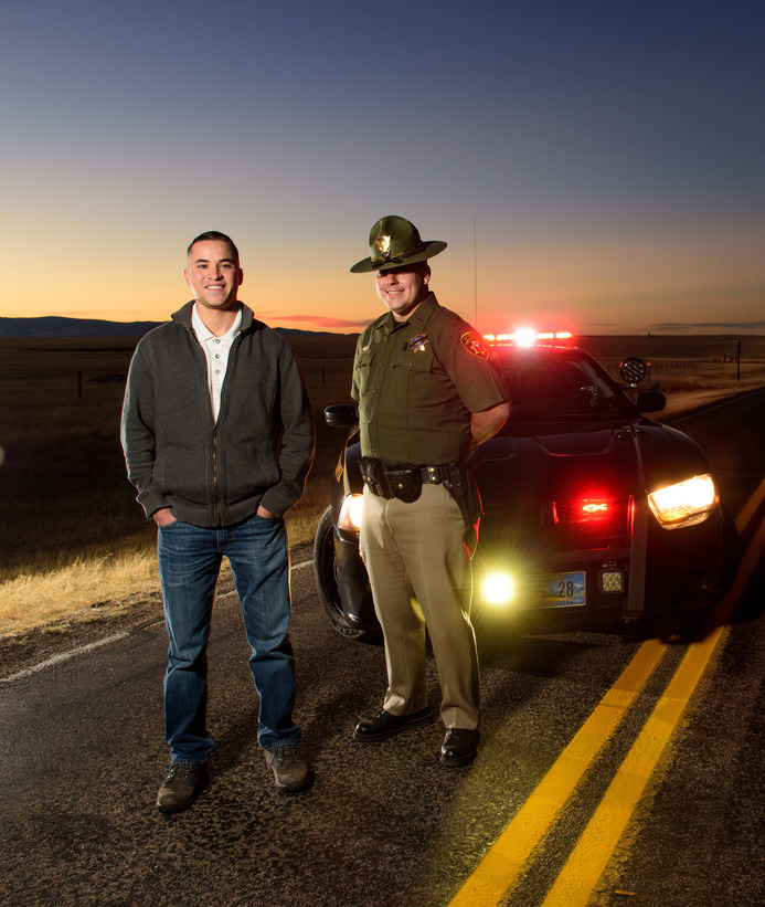 State troopers stand in front of police car