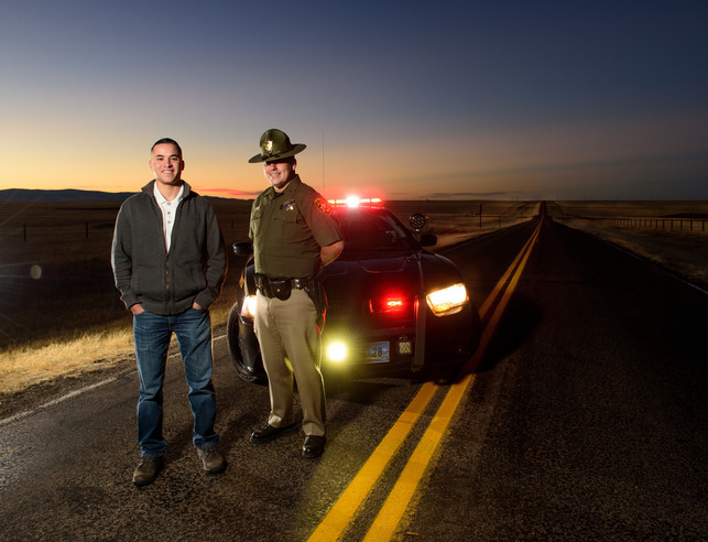State troopers stand in front of police car