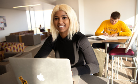 A criminal justice student smiles for a photo during class