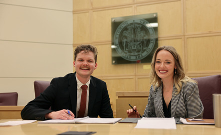 Two law students smile for a photo
