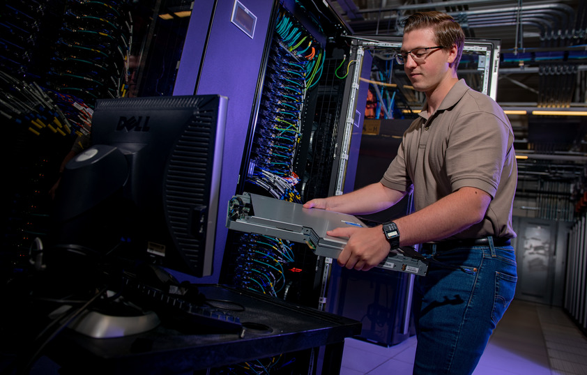 Person working on a large frame computer