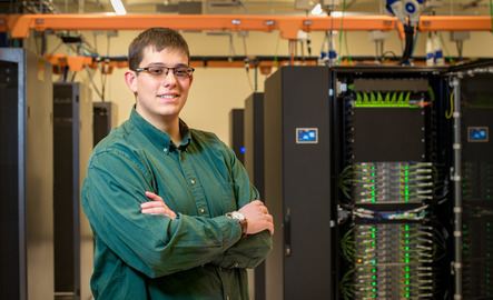 Person in front of large frame computers
