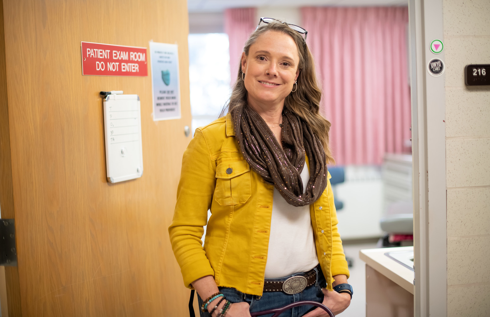 A health service worker stands in a doorway