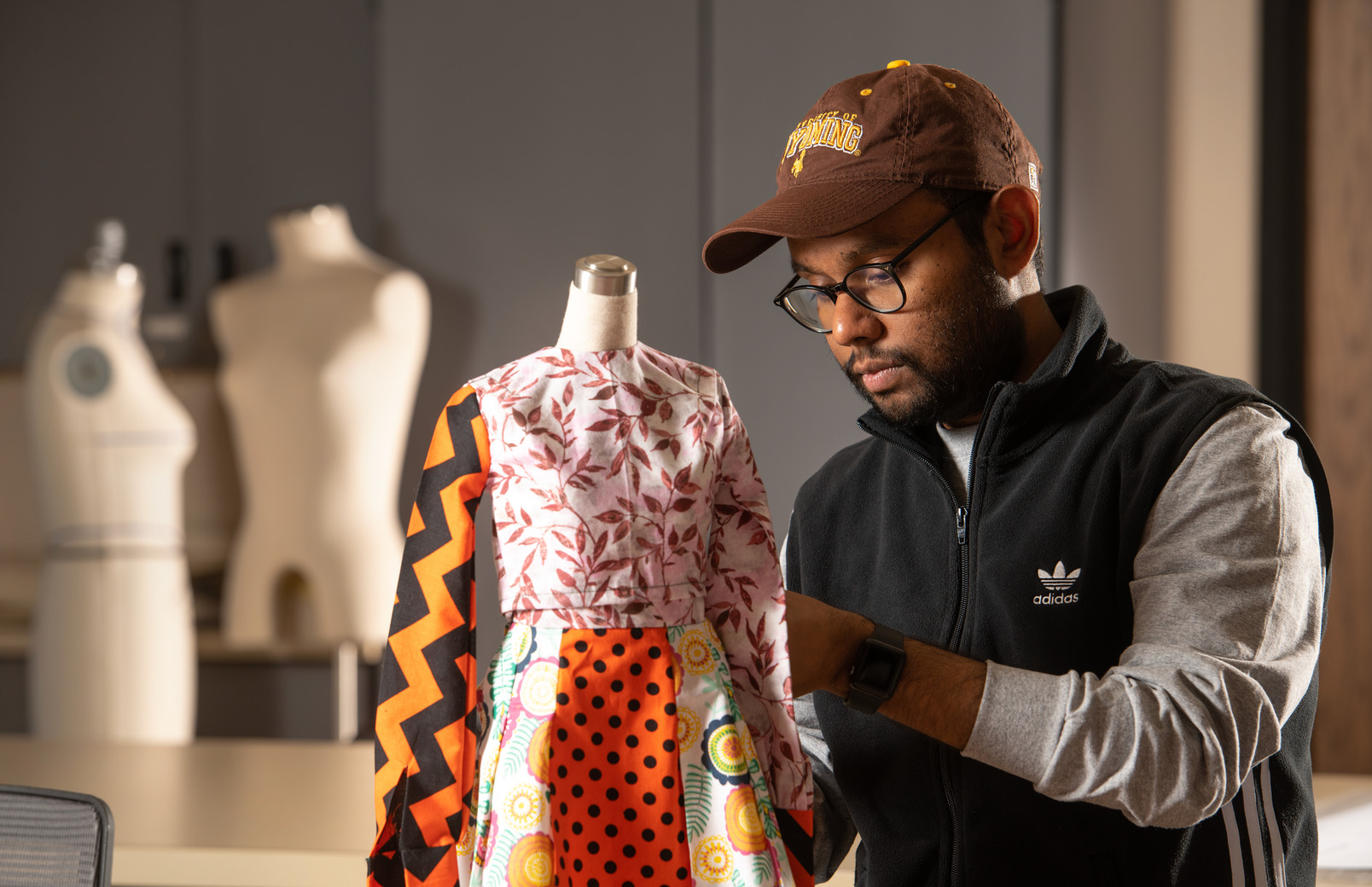 Student working on an outfit on a mannequin