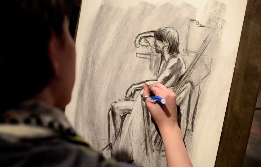 Student drawing in class