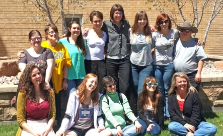 A professor takes a picture with her class