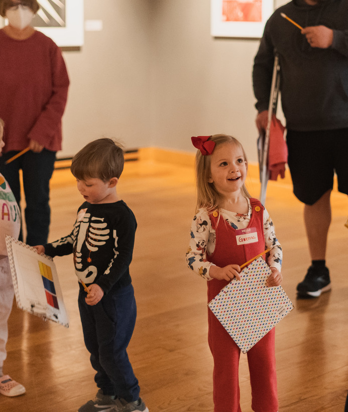 Two children holding their artwork