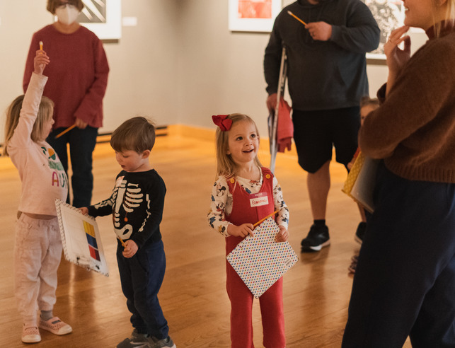 Two children holding their artwork