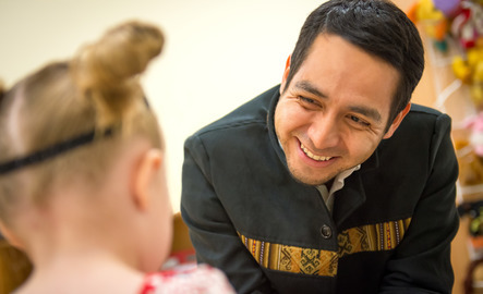 Early childhood teacher smiling at student