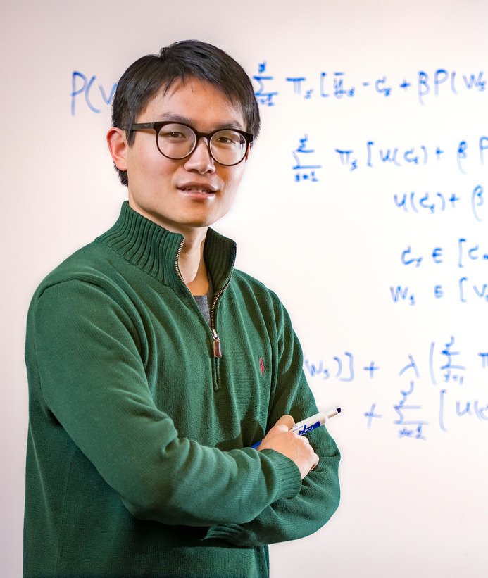 Student posing in front of white board