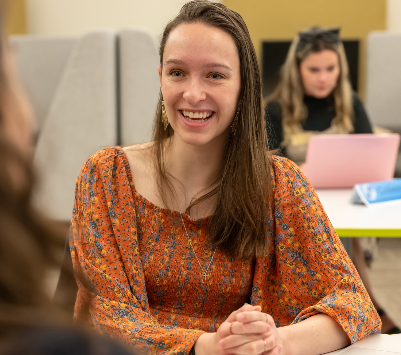 Student smiling at other student