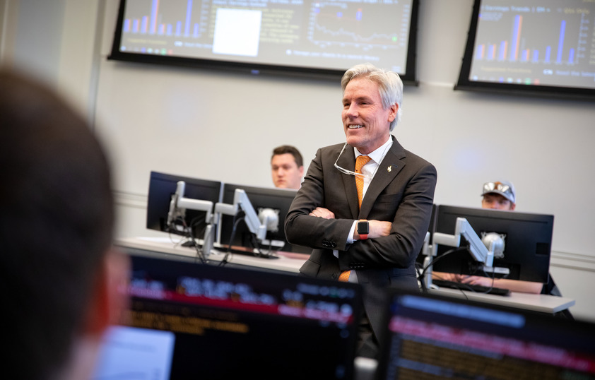 A professor smiles while teaching a class