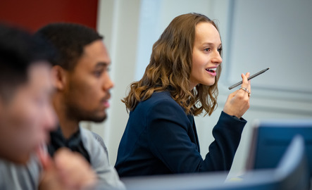A student smiles during business class