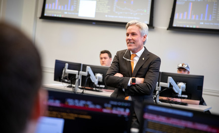 A professor smiles while teaching a class