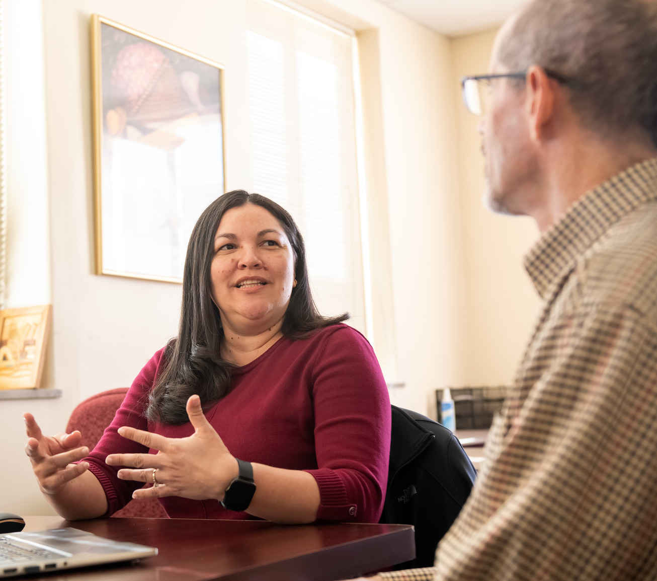 Two colleagues in office talking