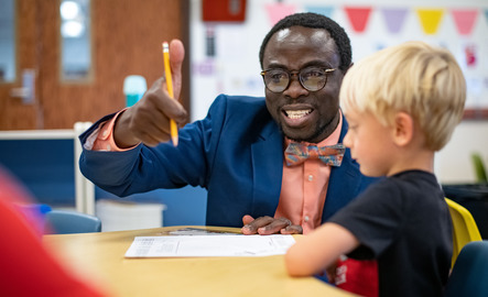 Teacher working with elementary student