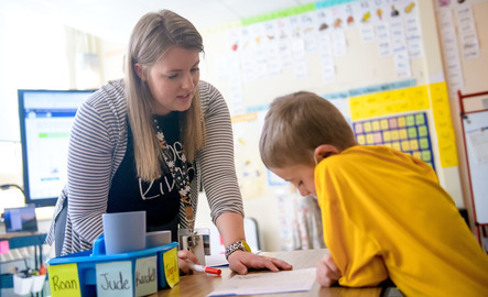Teacher working with student