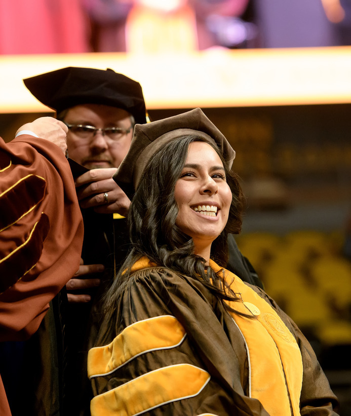 A graduate getting hooded at commencement