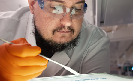 An electrical engineering student in a lab