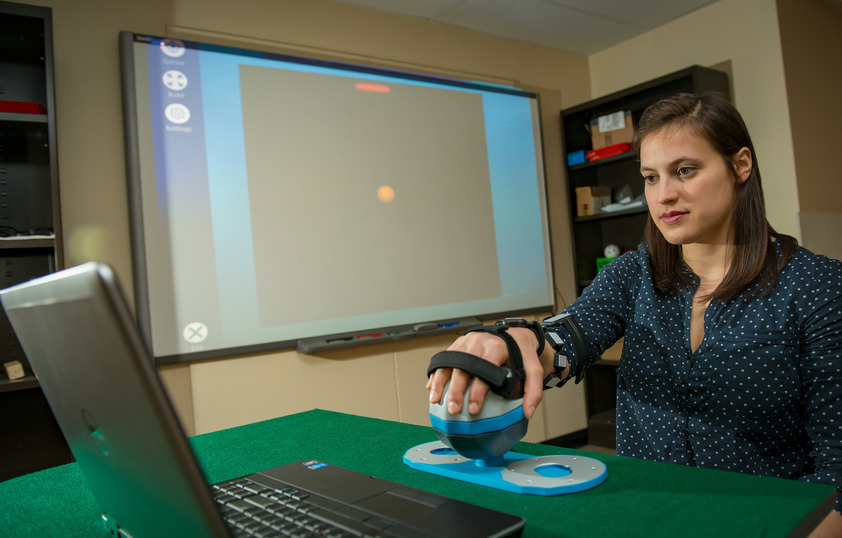A student using a electrical engineering invention in a lab