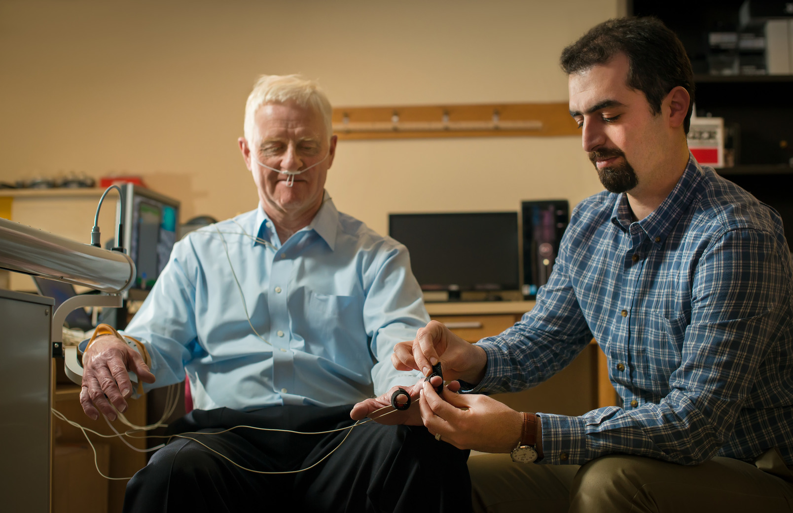 A professor hooks up a client to his machine