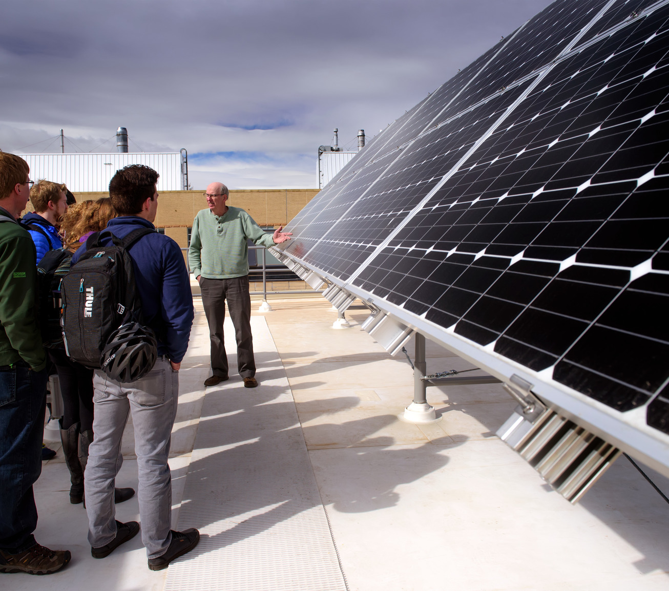 Students and professor looking at solar panels