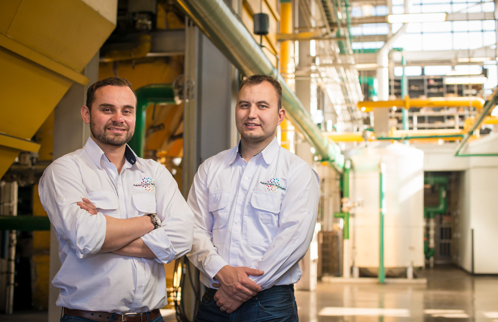 Two UW alum posing for photo in their business