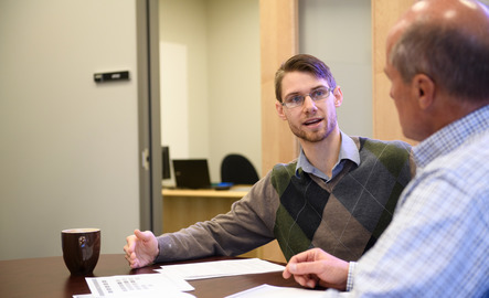 Two people having a discussion at a conference table