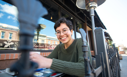 Student sitting outside at a local coffee shop