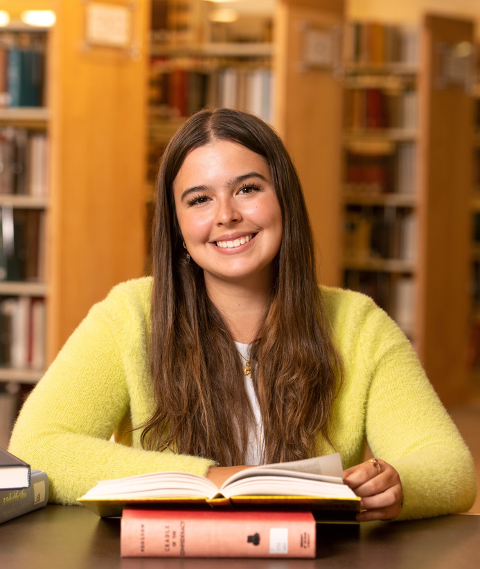 Student opening a book in the library