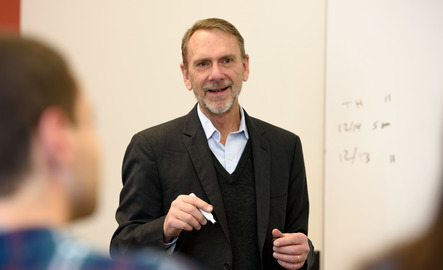 Professor teaching in front of classroom