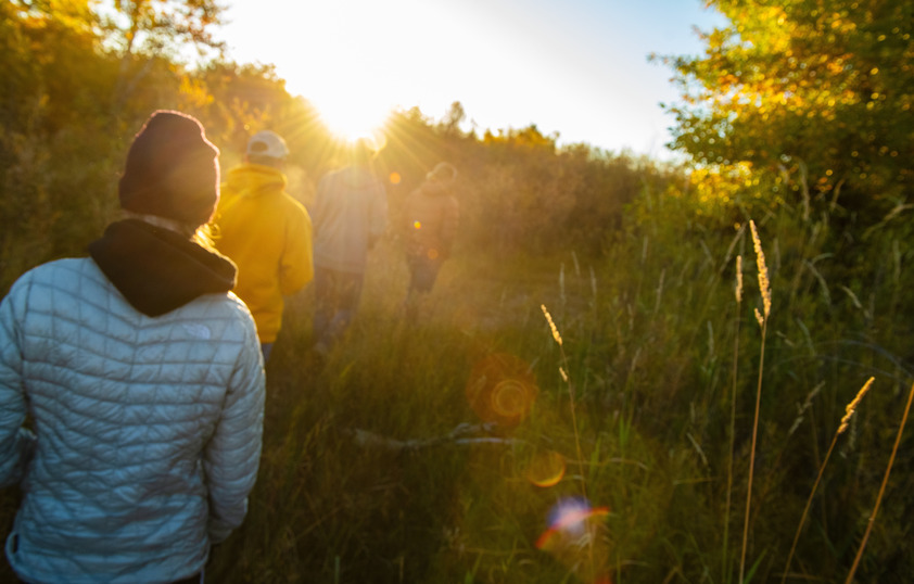 students hiking in a field