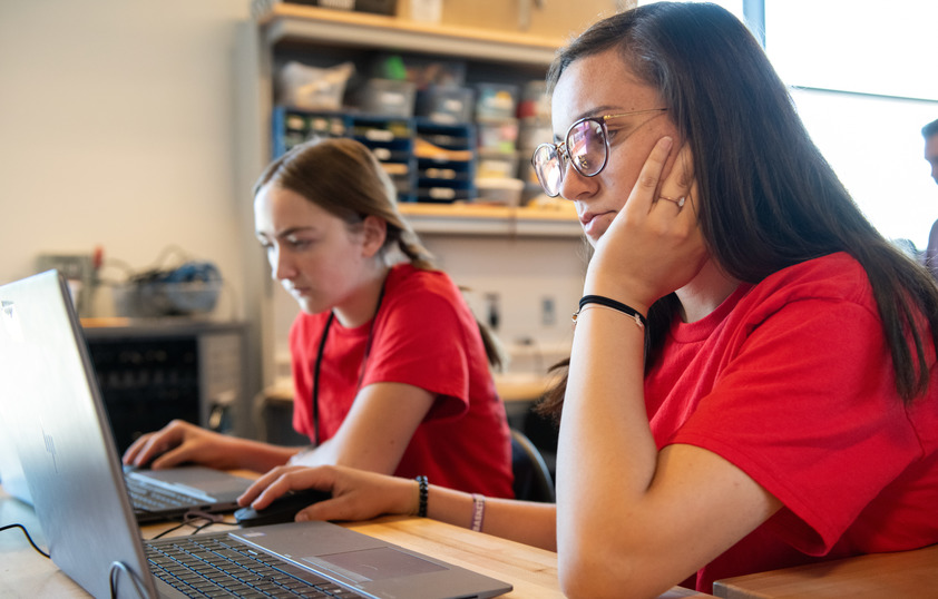 Two students working on laptops