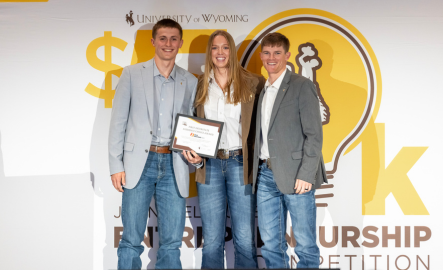 Three entrepreneurship students smile at the camera