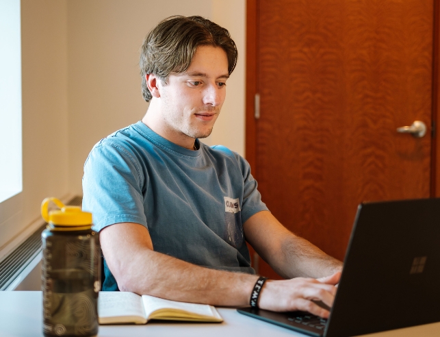 A student works on a laptop