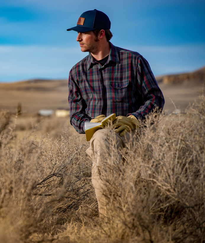 A student out in the field with a notebook