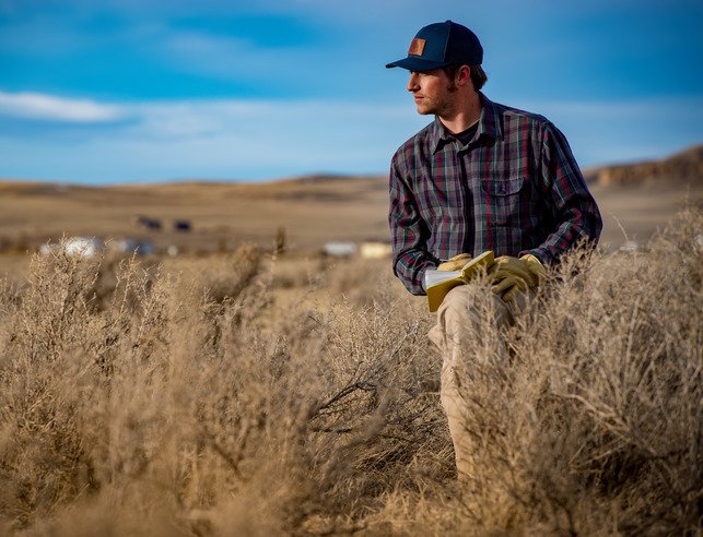 A student out in the field with a notebook