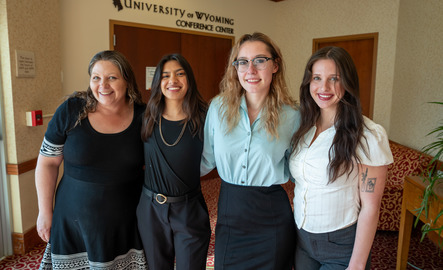 Four students stand together for a picture