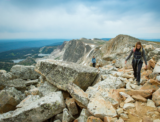 Students walking on a trail with mountains in the background