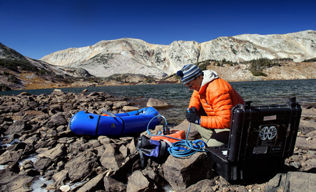 Professor out in the field next to a body of water