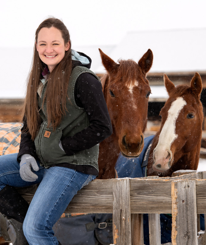 Equine science student with two horses