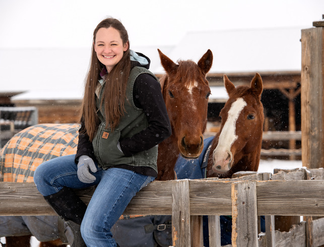Equine science student with two horses