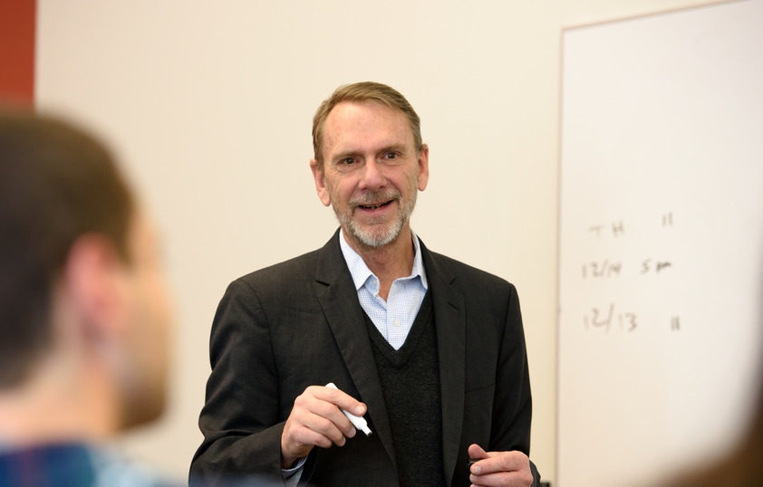 Professor teaching in front of classroom