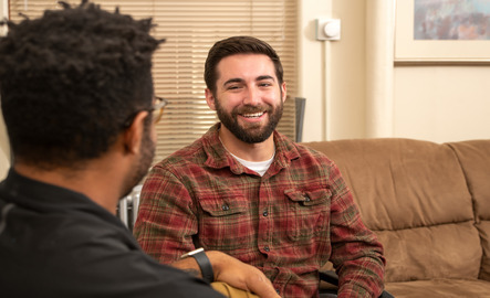 Two people talk and smile at each other