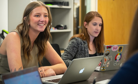 Two students on laptops during class