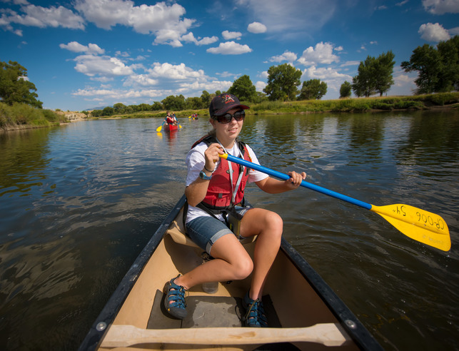 A student canoes down a river
