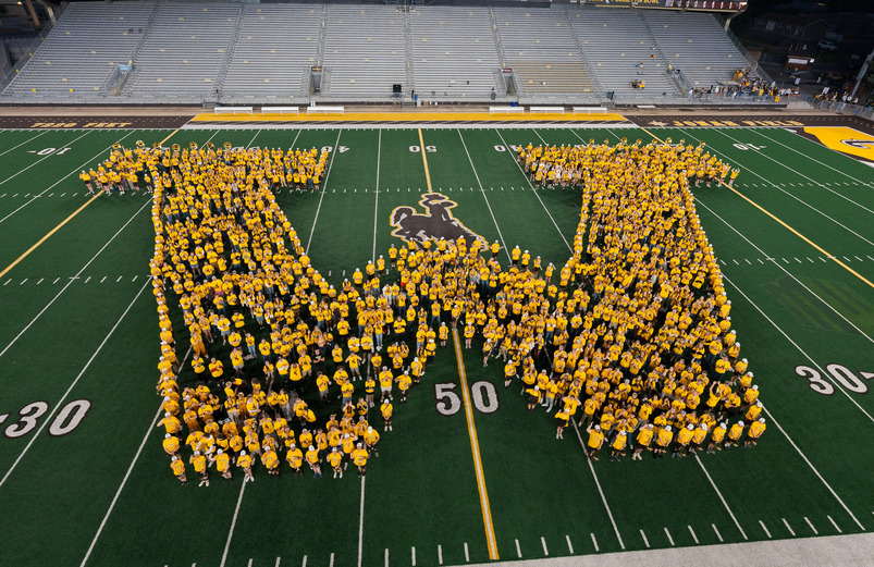 An incoming freshmen class form a "W" on the football field