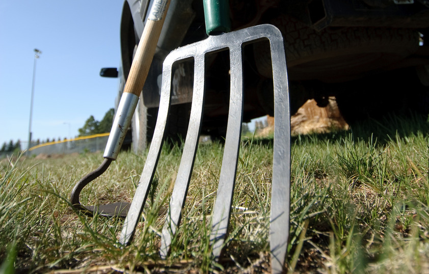 A pitchfork leans against a pickup