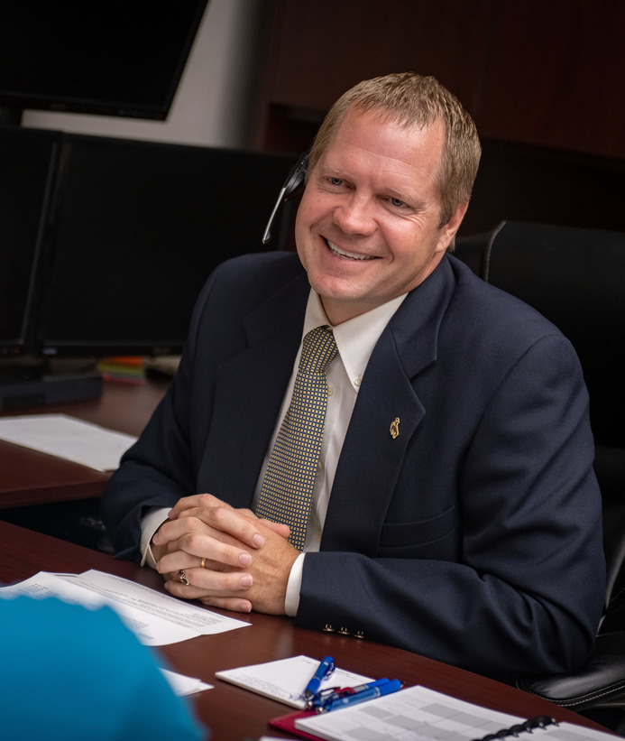 Banker sitting at a desk talking to a client